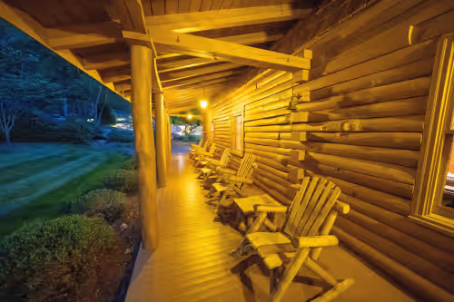 Front Porch with Six Rocking Chairs at Luxury Mountain Cabin On 320+ Acres Near Asheville, Lake Lure & Hendersonville