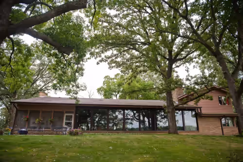 Lake is behind the photographer. Screened porch on left. Patio and firepit. at Family Retreat, private, large, great for