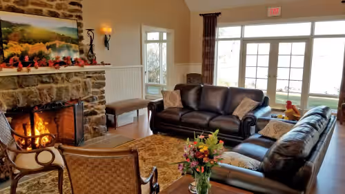 Main House - Living Room with fireplace, smart TV, and water view at Amazing 432-Acre Waterfront Estate ~ Dock ~ Kayaks ~