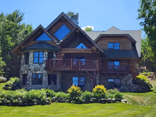 Beautiful handmade log home on private sand beach at the end of Big Bay