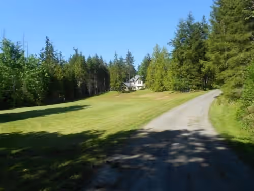 Grass area heading from play field up to house. at Come Experience Our Country Home Where Kids Entertain Themselves