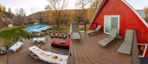 Panorama from the UPPER sundeck, across the main deck, to the pool. at 3 Acres of Family Reunion Bliss. Sleeps 50. Private