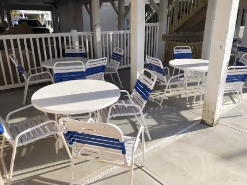 Outdoor dining at LARGEST OCEANFRONT POOL ON ISLAND LOCATED 1/4 MILE EAST OF PIER12 Bedroom 8 Bath