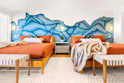All bedrooms feature comfortable beds, artistic wall murals, and plush throws. at Treetop Lakehouse: Pvt