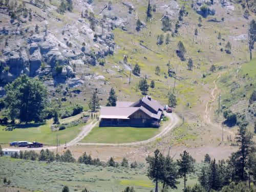 Large log building in the country near a creek