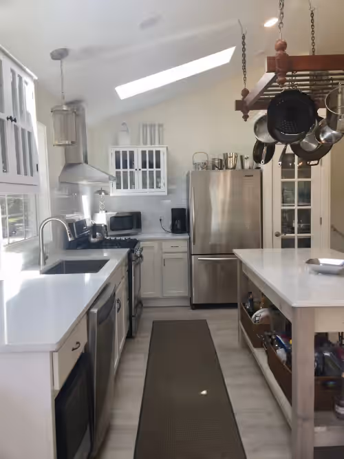 Kitchen with stunning quartz counters, island open to dining and living, views at EXCLUSIVE LAKEFRONT with beach, beach