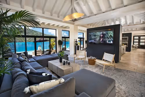 The spacious and comfy living room with AC, and 75` flat screen TV. at The BEST Wedding Spot! 2 pools, gym, beachfront &