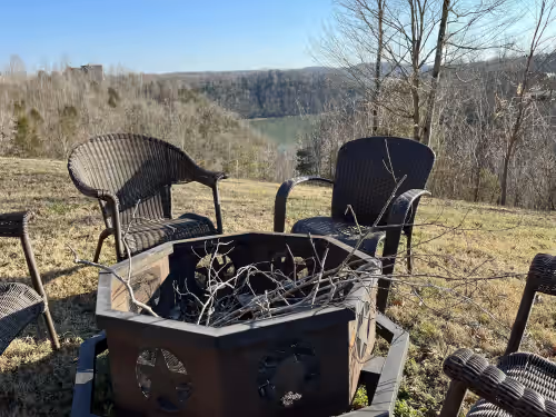 Enjoy an evening around the firepit at Updated Game Room with Arcade Style Games, 7 BR, 2 Kitchens, sleeps up to 25