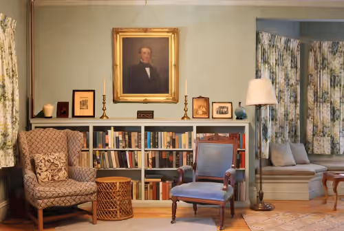 Living room overseen by great-great-grandfather at Victorian Splendor Amidst the Mountains
