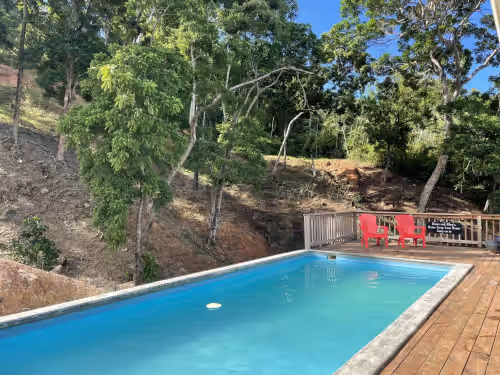 Pool at A Quiet East End Retreat. Ocean view with a private pool and custom water slide