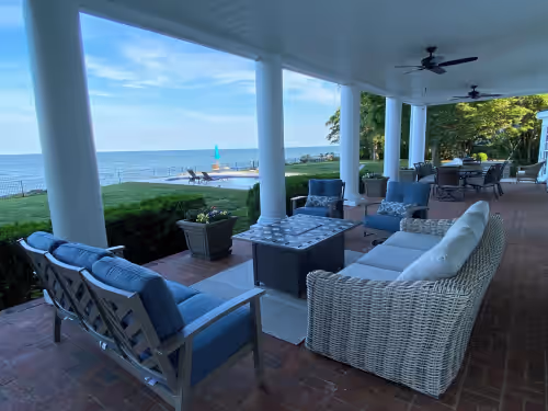 Bay/pool front lounge with fire table at Chesapeake Bay-front Estate minutes to Irvington, Kilmarnock Whitestone