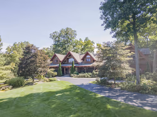 Exterior at Log Cabin Mansion fronting Strawberry and Bass Lake with large oversized suites