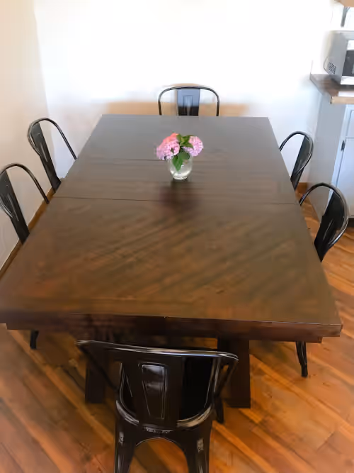 Dining table open to kitchen and living room at Secluded farmhouse retreat
