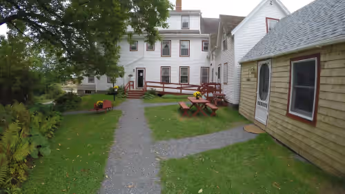 View of the Sea Captain's House and library building from the ample parking area at Sea Captain's on 200 acres & Sand Beach,