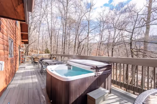 Expansive deck with hot tub, outdoor seating, and firetable at Grand Log Home Billiard Table 5000 sq feet Hot Tub FirePit