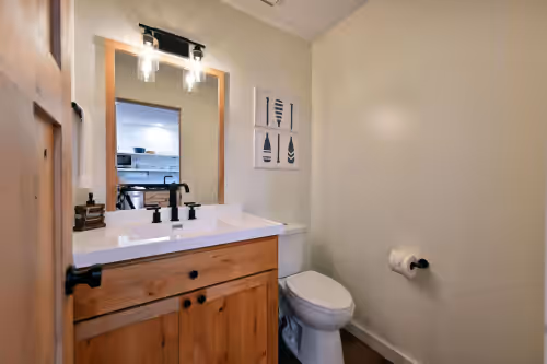 Main level half bathroom at All 4 lakefront condos! Private beach, dock, sauna, club room, decks