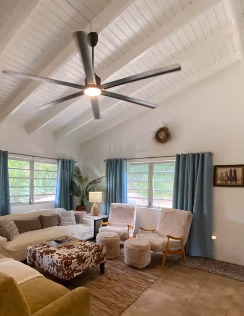 Surfer Shack living area with large TV, plenty of sitting space and king size sofa bed at Vibeinn: 9 Bedroom House w