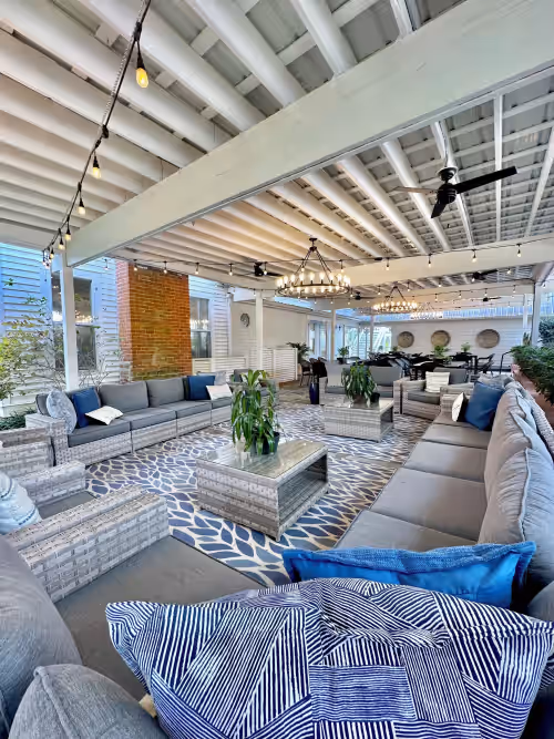 Back patio of the main house! Dining for 40 & Tons of lounge furniture. at “The Magnolia House” LakeFront Compound Sleeps