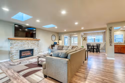 Main Living Room with 65" UHD TV, HBO, Disney+ and Netflix for movie nights! at One of a Kind Modern Farmhouse Estate