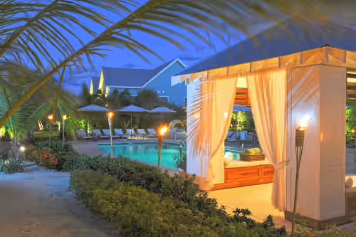 Cozy pool cabana at dusk. at Sea Orchard Retreat: Gated Micro-Resort Near 7 Mile Beach w/Shared Pool & Jacuzzi