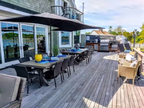 Outdoor dining at Luxury Waterfront Home Sleeps 16 Game Room Private Beach and Dock