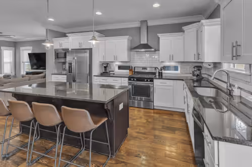 Kitchen equipped with high-end appliances, a sprawling island with seats for 4, custom cabinetry at Downtown Mansion TWO
