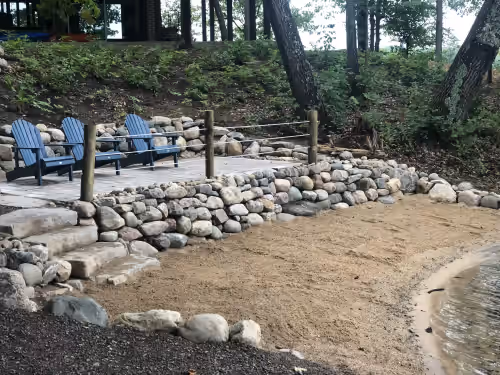 Beach area and stone patio at Bellaire Waterfront Private Retreat, beach, dock, 5-star experience