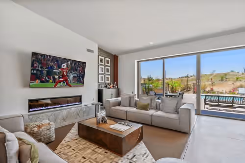 Estate 1: Spacious, light and bright living room featuring an electric fireplace, wet bar, Smart TV and designer