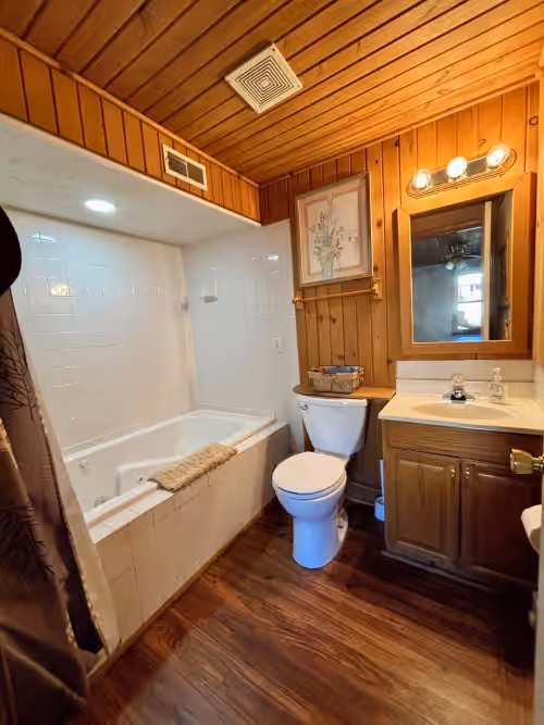 First floor bathroom - ensuite to bedroom w/ jacuzzi tub at HUGE 3 Home Lodge For Large Groups, Lots of Space For