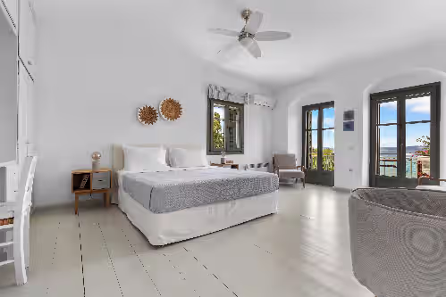 Wake up to stunning sea views from this spacious bedroom with a king-size bed. at Exclusive Beachfront Villa with Swimming