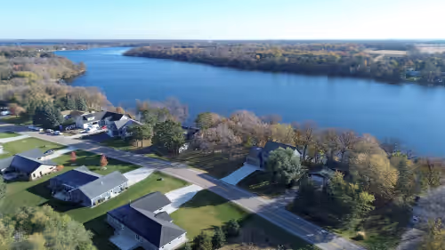 Aerial view of home and Lake Victoria at New Construction on Beautiful Lake Victoria! Close to town