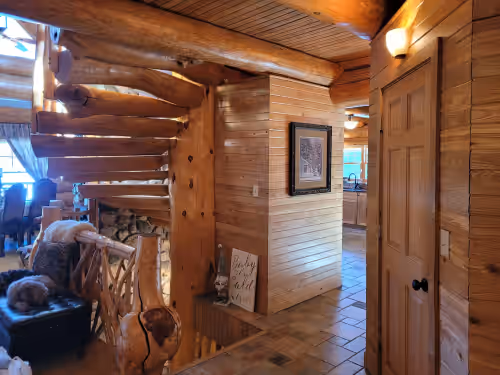 Main entryway stairs at Beautiful handmade log home on private sand beach at the end of Big Bay